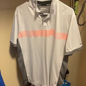 Light gray large NIKE golf shirt with orange stripes, dark Gray on side